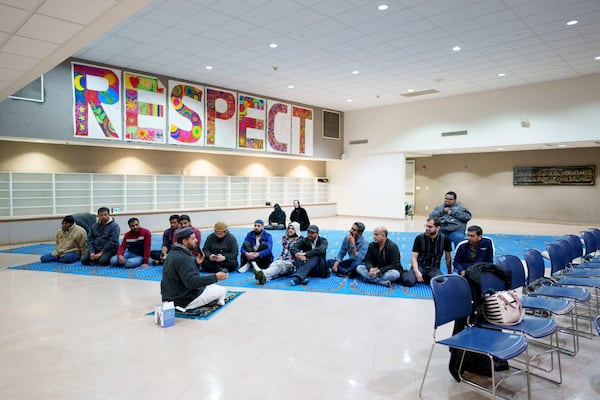 Members of an Altadena mosque, which burned in the Eaton fire, discuss plans for Ramadan after prayer during a community gathering held at New Horizon Islamic School in Pasadena, California, Saturday, Feb. 15, 2025. (AP Photo/Eric Thayer)