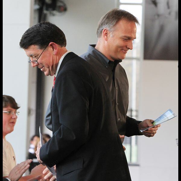 The AD and the football coach. (Curtis Compton/AJC)