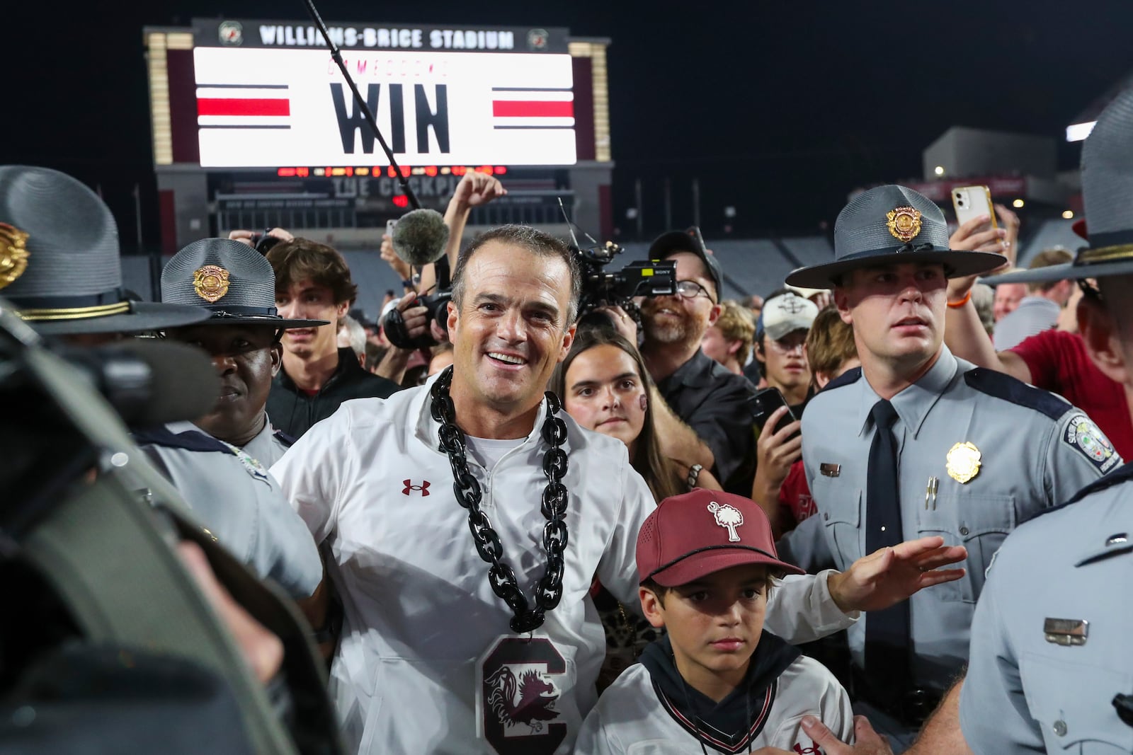 South Carolina head coach Shane Beamer leaves the field while fans storm the field after an NCAA college football game against Texas A&M Saturday, Nov. 2, 2024, in Columbia, S.C. South Carolina upsets Texas A&M 44 - 20. (AP Photo/Artie Walker Jr.)