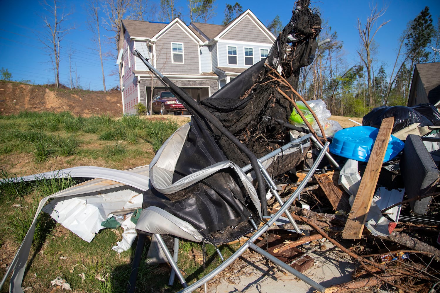 The kids' trampoline in Brittany Mitchell's yard was left as a warped heap of metal after the tornado ripped through the neighborhood. (Alyssa Pointer / Alyssa.Pointer@ajc.com)