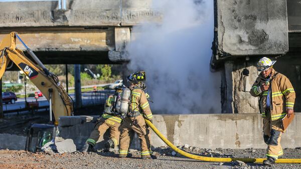 The fire that caused the collapse of a portion of the northbound section of I-85 just south of Ga. 400 near Piedmont Road continued to burn Friday, March 31, 2017, as fire crews and transportation workers examined what remained of the highway. The interstate remained closed in both directions.