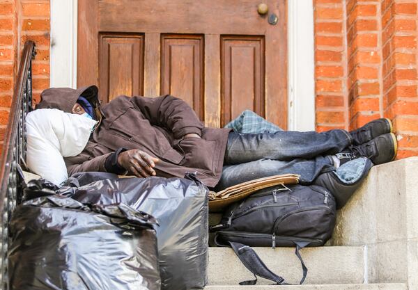 Homeless people congregate along Martin Luther King Jr. Drive in Atlanta and some sleep on the steps of the Catholic Shrine of the Immaculate Conception in this January 2021 file photo. (Jenni Girtman for The Atlanta Journal-Constitution)