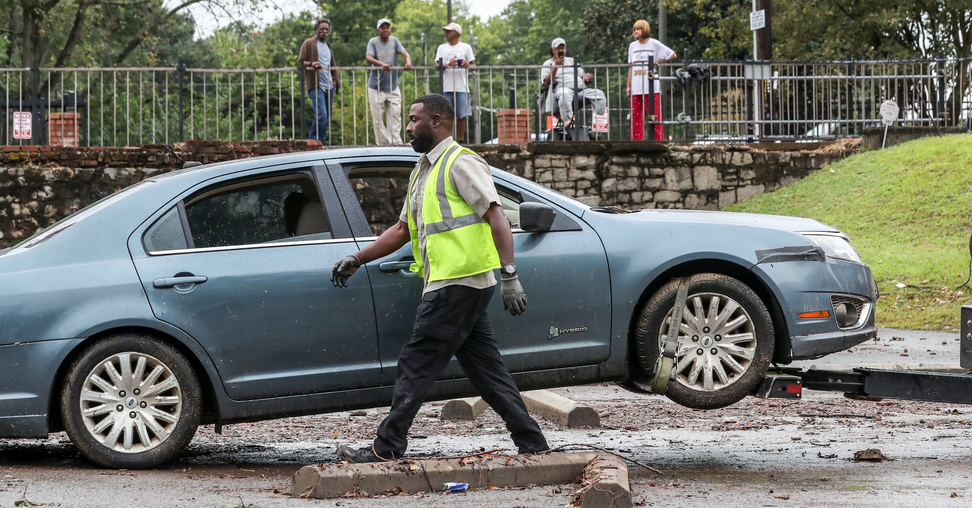  A-Tow driver Jerome Gaines readies to tow aone of two vehicles carried by flood waters in a church parking lot at Central United Methodist Church located at 501 M.L.K. Jr. Drive SW, in Atlanta sat idle Friday morning, Sept. 15, 2023 hours after flash flood water inundated the downtown area.  (John Spink / John.Spink@ajc.com)

