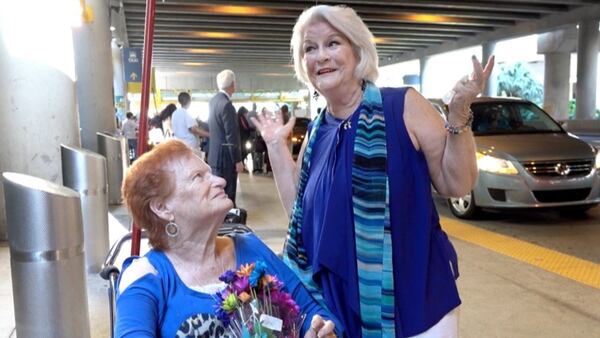 Toni Rosenberg, right, of Boca Raton, Florida, meets her sister Florence Serino for the first time at Fort Lauderdale-Hollywood International Airport on Tues. Serino had just arrived from her home in Irvine, California.