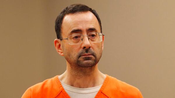 FILE - In this Nov. 22, 2017, file photo, Dr. Larry Nassar, appears in court for a plea hearing in Lansing, Mich. Nassar, an elite Michigan sports doctor who possessed child pornography and assaulted gymnasts, was sentenced Thursday, Dec. 7, 2017,  to 60 years in federal prison in one of three criminal cases that ensure he will never be free again. (AP Photo/Paul Sancya, File)