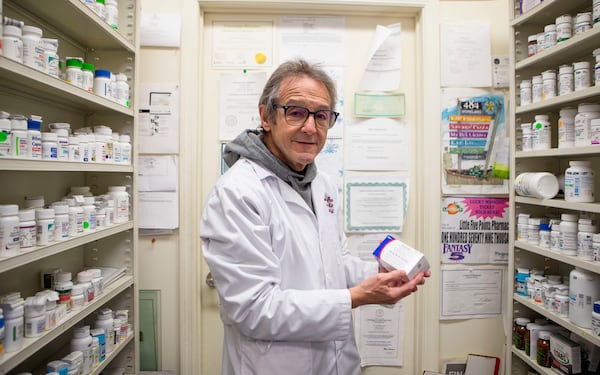 Pharmacist Ira Katz poses for a portrait with Paxlovid, a Covid-19 treatment medication, at Little Five Points Pharmacy on Friday, December 23, 2022, in Atlanta. Katz distributes Paxlovid to those with a prescription. CHRISTINA MATACOTTA FOR THE ATLANTA JOURNAL-CONSTITUTION.