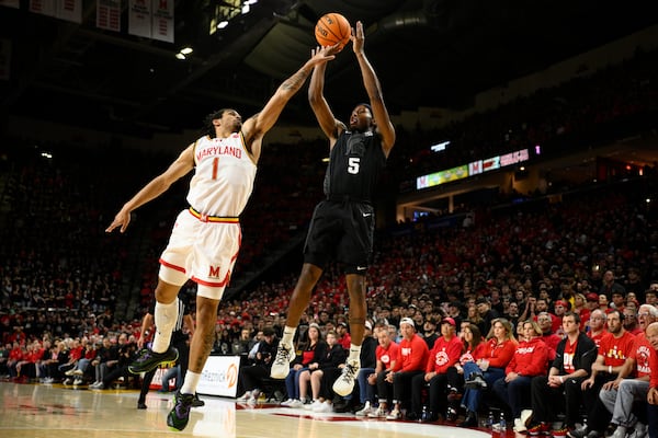 Michigan State guard Tre Holloman (5) shoots against Maryland guard Rodney Rice (1) during the first half of an NCAA college basketball game, Wednesday, Feb. 26, 2025, in College Park, Md. (AP Photo/Nick Wass)