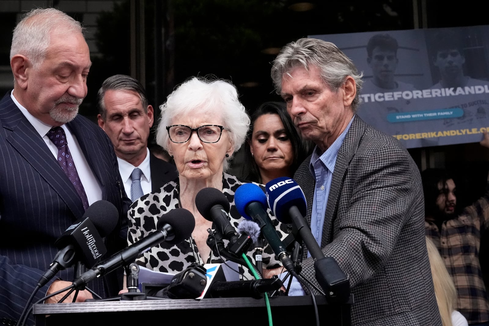 Kitty Menendez' sister, Joan Andersen Vandermolen, center, walks up to podium to make a statement during a press conference to announce developments on the case of brothers Erik and Lyle Menendez, Wednesday, Oct. 16, 2024, in Los Angeles. (AP Photo/Damian Dovarganes)