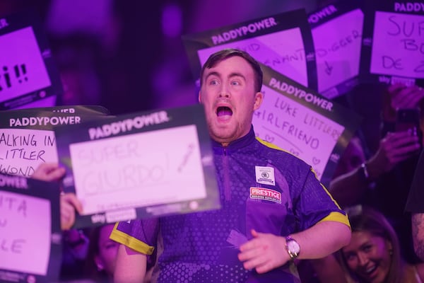 FILE - Luke Littler of England arrives for the quarterfinal match against Brendan Dolan of Northern Ireland at the World Darts Championship, in London, Monday, Jan. 1, 2024. (AP Photo/Kin Cheung, File)