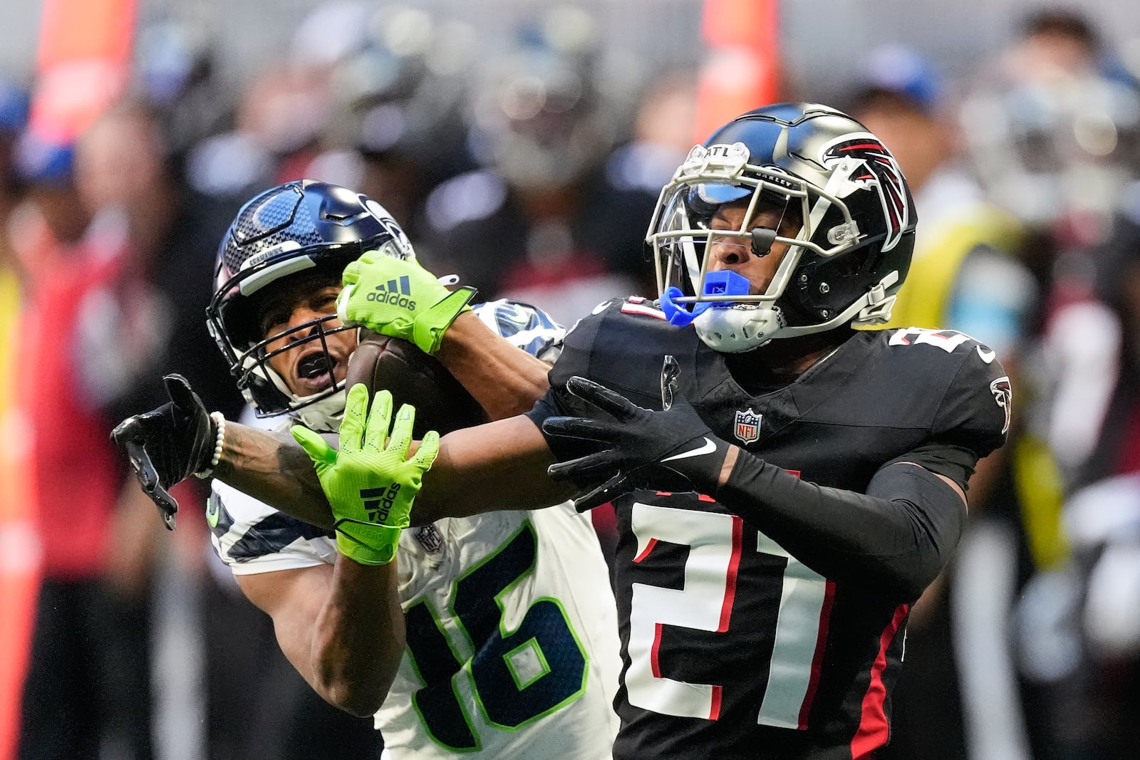 Atlanta Falcons safety Richie Grant (27) breaks up a pass intended for Seattle Seahawks wide receiver Tyler Lockett (16) during the second half of an NFL football game, Sunday, Oct. 20, 2024, in Atlanta. (AP Photo/ Mike Stewart )