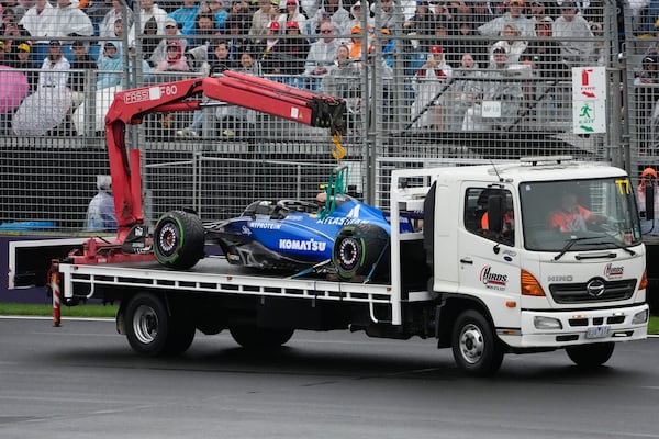 Williams driver Carlos Sainz of Spain's car is taken from the track after he crashed during the Australian Formula One Grand Prix at Albert Park, in Melbourne, Australia, Sunday, March 16, 2025. (AP Photo/Asanka Brendon Ratnayake)