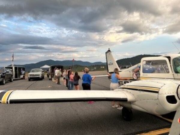 A line of volunteers unload supplies off of a plane and into a truck at the Jackson County Airport in Sylva, North Carolina, on Friday, Oct. 4, 2024. Provided by Michelle Curcio