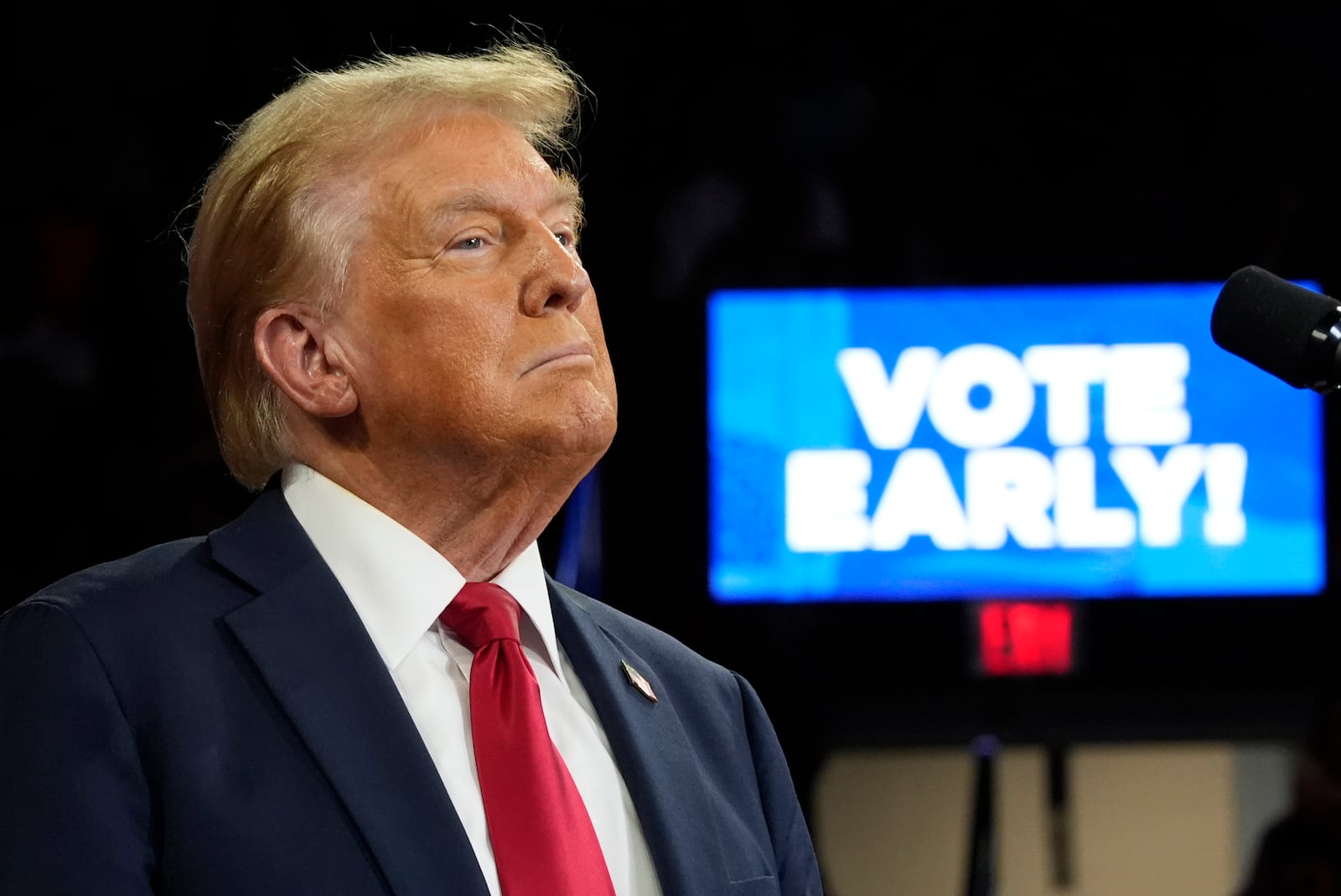 With "Vote Early" displayed on a screen behind, Republican presidential nominee former President Donald Trump speaks at a campaign rally at the Santander Arena, Wednesday, Oct. 9, 2024, in Reading, Pa. (AP Photo/Alex Brandon)