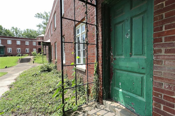 A boarded-up door on an empty brick building that was once part of Techwood Homes on Monday, Aug. 2, 2021, in Atlanta. Curtis Compton / Curtis.Compton@ajc.com