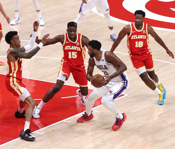 Hawks players (from left) John Collins, Clint Capela and Solomon Hill triple team Philadelphia 76ers center Joel Embiid.   “Curtis Compton / Curtis.Compton@ajc.com”