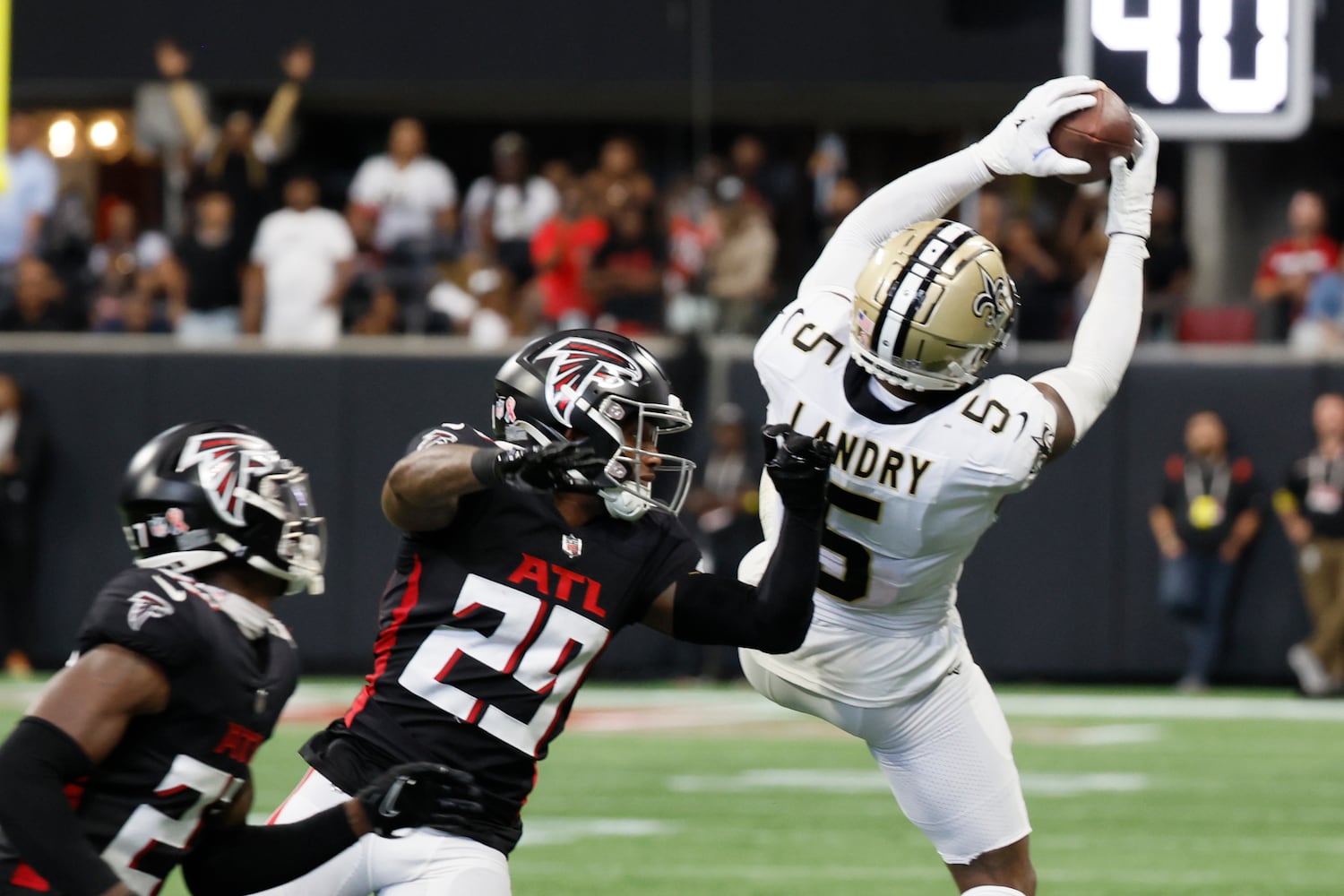 Saints receiver Jarvis Landry catches a pass under pressure from Falcons cornerback Casey Hayward during the fourth quarter Sunday. (Miguel Martinez / miguel.martinezjimenez@ajc.com)
