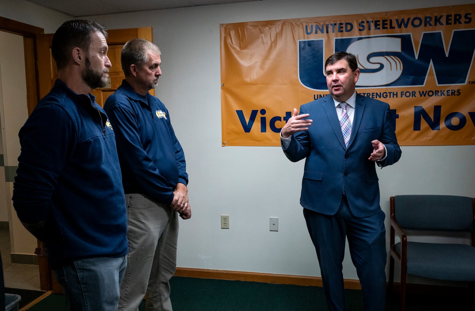 From left, Cary Eldridge, United Steelworkers (USW) Sub District Director, Syracuse office, and Jack Vanderbaan USW Staff, Syracuse, listen as New York State Senator John Mannion, Democratic candidate for New York's 22nd congressional district, meets with representatives and members of the United Steelworkers in Geddes, N.Y. Thursday. Oct. 24. 2024. (AP Photo/Craig Ruttle)