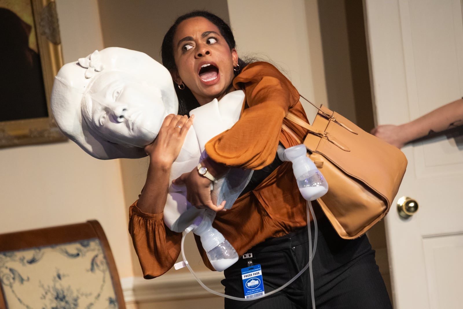 Journalist and new mother Chris (Camille Monae) wields a bust of women’s rights leader Alice Paul.