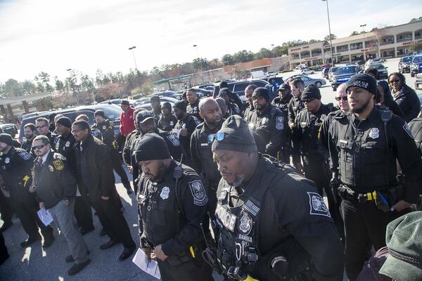 Members o the DeKalb County Police Department participate in a community roll call at the Wesley Center Square shopping center in Decatur, Wednesday, January 20, 2020. (ALYSSA POINTER/ALYSSA.POINTER@AJC.COM)