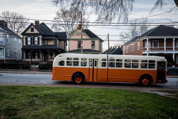 A 1950s-era bus similar to the bus that civil rights leader Rosa Parks rode in Montgomery, Alabama, when she was arrested in 1955 sits in front of the birthplace of Dr. Martin Luther King Jr. in Atlanta.