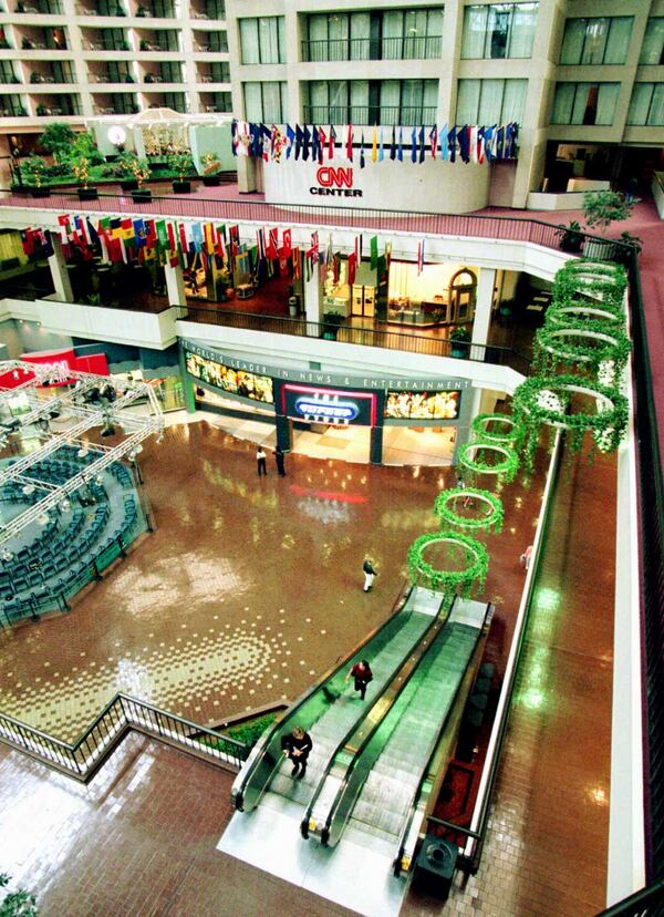 Pedestrians ride the escalators in the CNN Center atrium to the office level in Atlanta Friday, Sept. 22, 1995. The Turner Store is in the background on the bottom level. (AP Photo/Ric Feld)