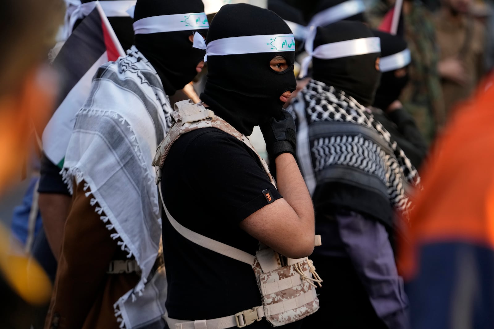 A group of the Iranian demonstrators cover their faces in the Palestinian and Lebanese militants style in a ceremony commemorating the late Hamas leader Yahya Sinwar and Hashem Safieddine, a powerful cleric who was expected to succeed slain Hezbollah leader Hassan Nasrallah and was killed by an Israeli airstrike in Beirut, at the Felestin (Palestine) Sq. in Tehran, Iran, Thursday, Oct. 24, 2024. (AP Photo/Vahid Salemi)