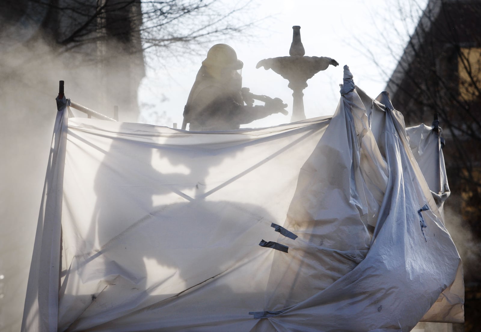 March 10, 2009: Remuijio Ortiz sandblasts the fountain in the middle of Marietta Square. Crews were stripping the new paint off to apply a new coat of epoxy primer and a coat of black epoxy paint with an antique finish.