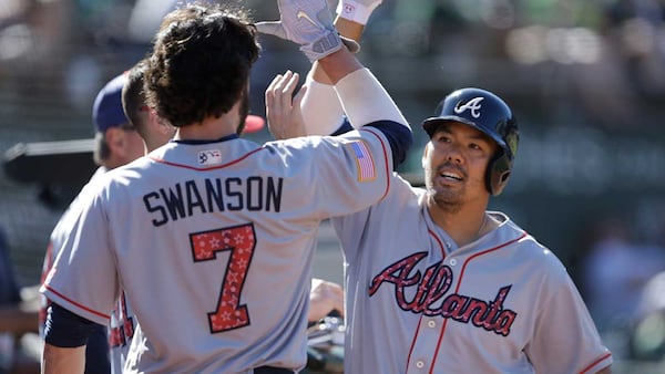 Kurt Suzuki celebrates with Dansby Swanson after his  home run in the 12th inning of Sunday's 4-3 win over Oakland.