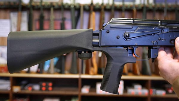 A bump stock device (left) that fits on a semi-automatic rifle to increase the firing speed, making it similar to a fully automatic rifle, is installed on a AK-47 semi-automatic rifle, (right) at a gun store on October 5, 2017 in Salt Lake City, Utah. Congress is talking about banning this device after it was reported to of been used in the Las Vegas shootings on October 1, 2017.  (Photo by George Frey/Getty Images)