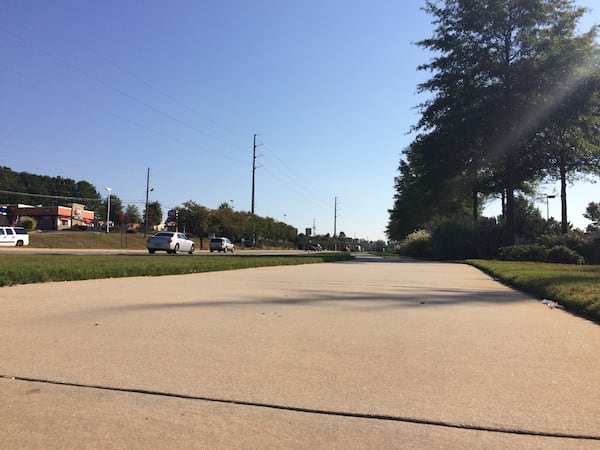 Dallas Highway sidewalk (BECCA GODWIN / BECCA.GODWIN@AJC.COM)