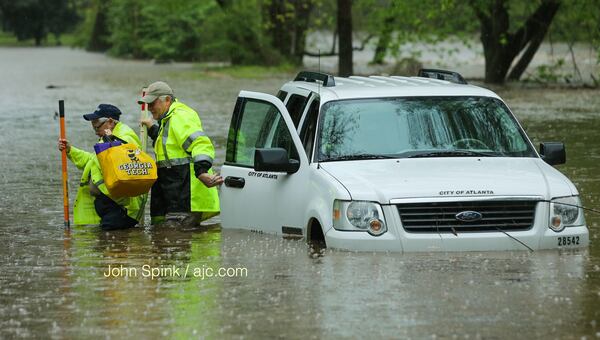 An Atlanta watershed management crew gets stuck on Woodward Avenue as Peachtree Creek overflows on Wednesday.