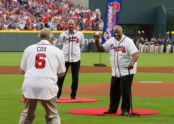 Hank Aaron throws out the first pitch to Bobby Cox with John Smoltz looking on at the Braves home opener against the Padres at SunTrust Park on Friday, April 14, 2017.