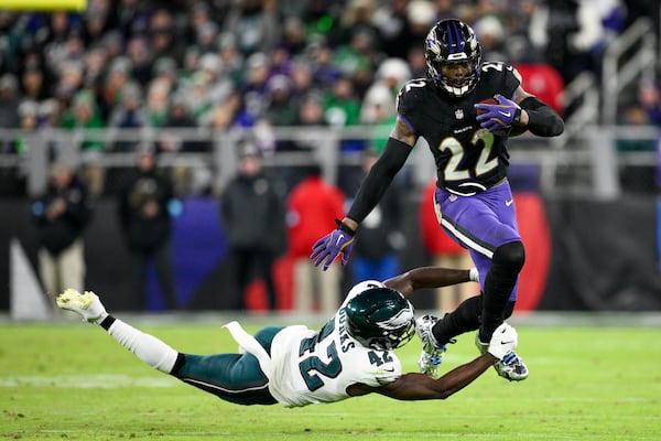 Baltimore Ravens running back Derrick Henry (22) avoids a tackle by Philadelphia Eagles linebacker Oren Burks (42) during the second half of an NFL football game, Sunday, Dec. 1, 2024, in Baltimore. (AP Photo/Nick Wass)