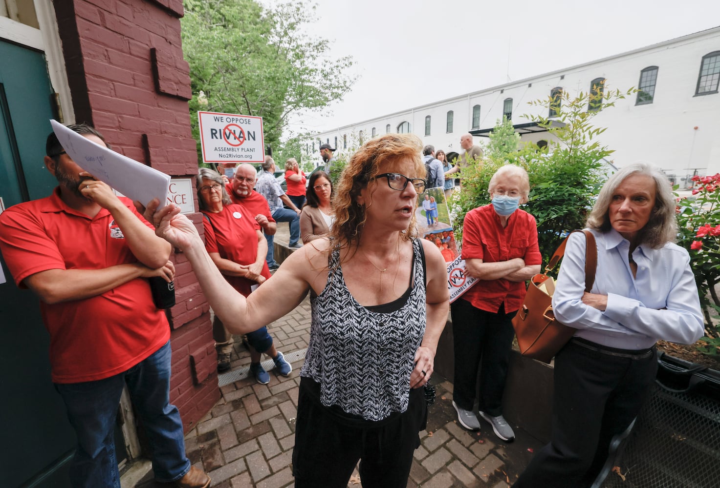 Lauri Tulis speaks out as those opposing the factory gathered outside after the Morgan County board of assessors voted to approve the Rivian tax exemption proposal in Madison on Wednesday, May 25, 2022.   (Bob Andres / robert.andres@ajc.com)