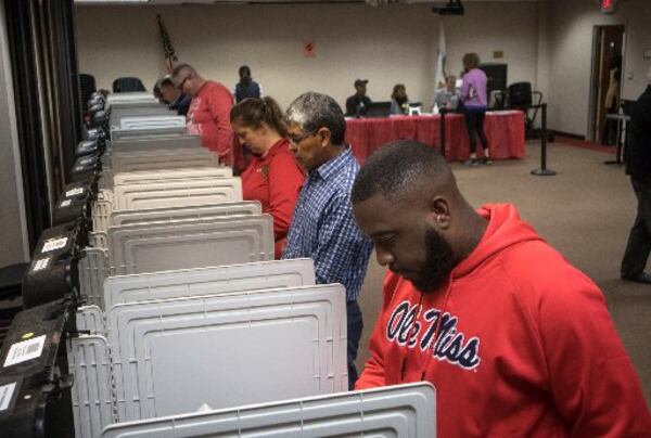 Middle school teacher Earnest Woodall casts his vote at Dekalb County Library-Dunwoody Branch on Saturday, Oct. 27, 2018. (Photo: STEVE SCHAEFER / SPECIAL TO THE AJC)