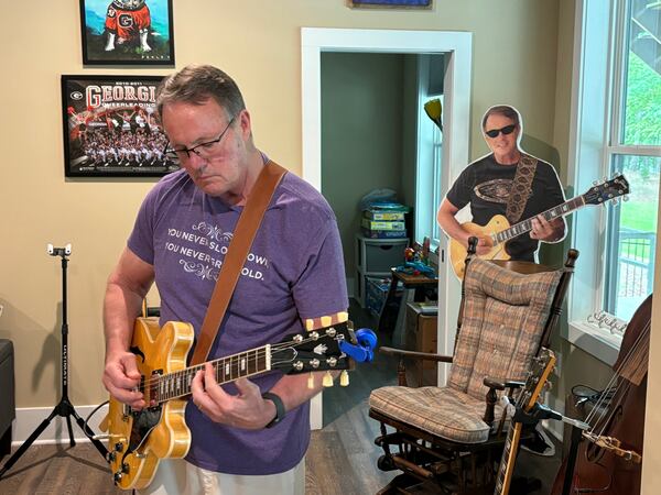 GHSA executive director Robin Hines can play any stringed instrument. Here he's playing along with a blue track he had recorded.