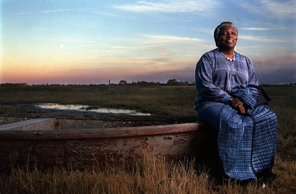 Cornelia Walker Bailey (cq) sits on a bateau on the edge of a Sapelo Island salt marsh. This bateau is one of the two traditional hand-made Geechee boats that still survives on the island. (BEN GRAY/STAFF)