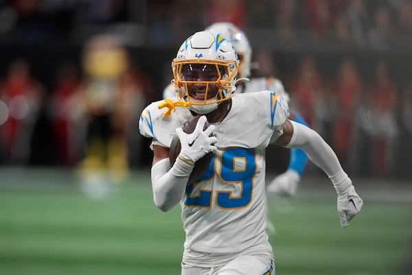 Los Angeles Chargers cornerback Tarheeb Still (29) returns an interception for a touchdown during the second half of an NFL football game against the Atlanta Falcons on Sunday, Dec. 1, 2024 in Atlanta. (AP Photo/Mike Stewart)