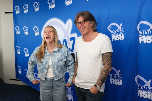 Taylor Scott (left) and Kevin Avery laugh as they are interviewed following their final broadcast of the Kevin & Taylor Show at the Fish 104.7 inside their studio on Friday, Jan. 31, 2025, in Atlanta. (Jason Getz/AJC)