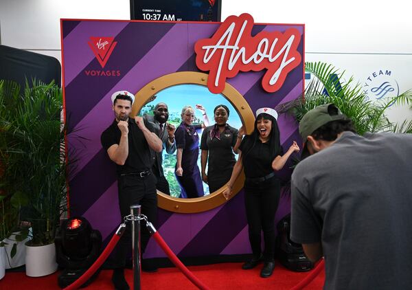 Crew members take their photos as Virgin Voyages and Delta host a full departure gate takeover prior to the flight's boarding at Hartsfield-Jackson Atlanta International Airport, Thursday, Feb. 29, 2024, in Atlanta. Sir Richard Branson, Delta Air Lines and Virgin Voyages surprised customers on Delta Flight 1946 (from ATL to SJU), gifting all an-board a free cruise to celebrate all-new itineraries and the brand’s growing presence in San Juan later this year. (Hyosub Shin / Hyosub.Shin@ajc.com)