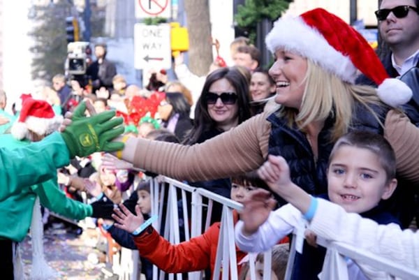 Emily Thomas Kendrick gives a high-five to parade marcher.