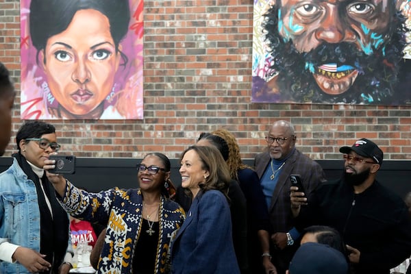 Democratic presidential nominee Vice President Kamala Harris, center, takes a photo with patrons during a campaign stop at Kuzzo's Chicken and Waffles in Detroit, Sunday, Nov. 3, 2024. (AP Photo/Jacquelyn Martin)