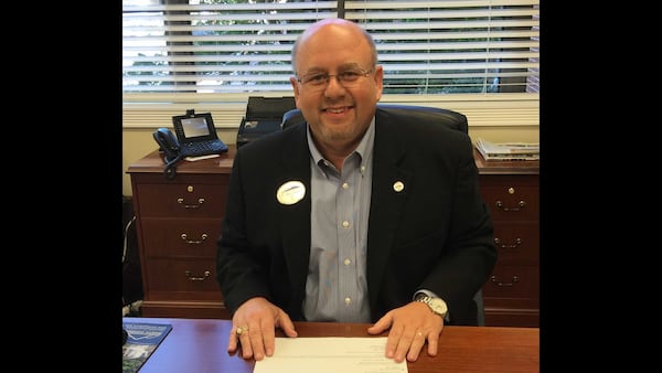 Mark Ivester, seated at his desk, became president of North Georgia Technical College in August 2016. He died on Sept. 12, 2020 from complications from COVID-19. PHOTO CONTRIBUTED.