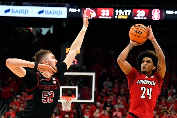 Louisville guard Chucky Hepburn (24) shoots over Stanford forward Aidan Cammann (52) during the second half of an NCAA college basketball game in Louisville, Ky., Saturday, March 8, 2025. (AP Photo/Timothy D. Easley)