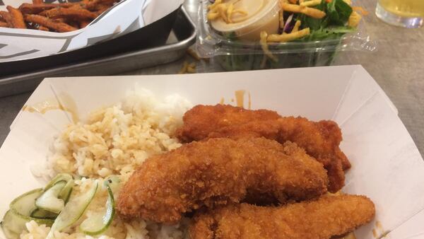 Ponko Chicken’s signature “Amer-Asian” chicken tenders are shown here with a side of “steamed and sticky” white rice and, in the background, sweet-potato fries and a house salad. CONTRIBUTED BY WENDELL BROCK