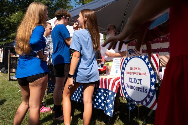 Youths gather around a Banks County Democratic Party booth during the Labor Day Festival in Homer on Aug. 31. (Ben Gray / Ben@BenGray.com)