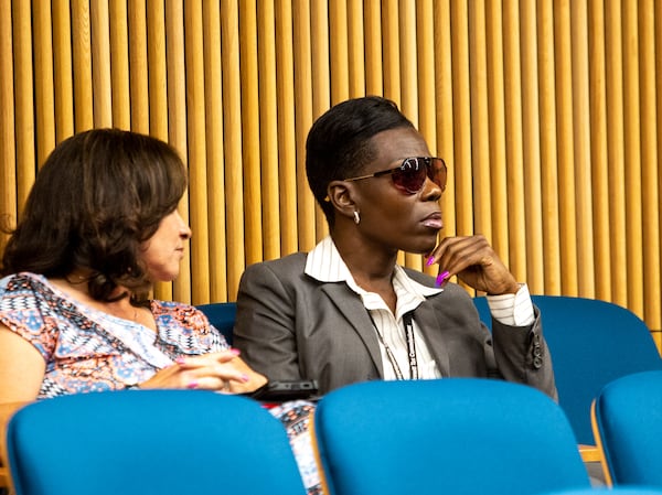 Tax commissioner Tiffany Porter, right, briefly attends the Gwinnett County Board of Commissions meeting Tuesday, June 15, 2021.   (Jenni Girtman for The Atlanta Journal-Constitution)