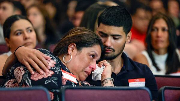 Alicia Garcia-Castellanos and her son Evan Castellanos react during presentations during the Shannon Melendi 30th Commemorative Senior Safety Assembly at Southwest Miami Senior High School in Miami, Florida on Tuesday, March 19.