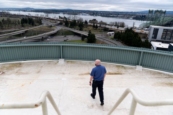 James Richardson, a Smith Tower Apartments employee, walks on the roof of the apartment complex, Monday, March 10, 2025, in Vancouver, Wash. (AP Photo/Jenny Kane)