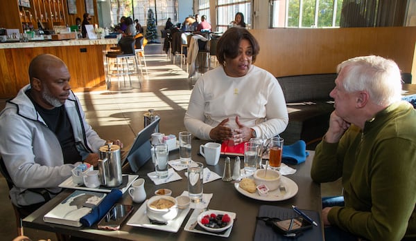 Dwight Zane Burney Sr. (from left), Shila Nieves Burney and Sig Mosley talk over breakfast at the Gathering Spot in Atlanta in 2021. (Phil Skinner for The Atlanta Journal-Constitution) 